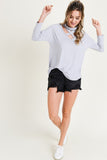 Grey blue top with mock neck and cross-cross detail in sizes S-L