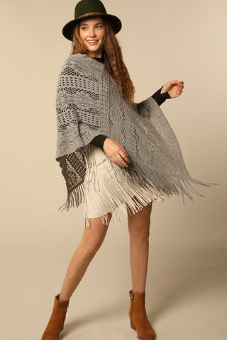 Lightweight crochet knit poncho in grey with tassel accent
